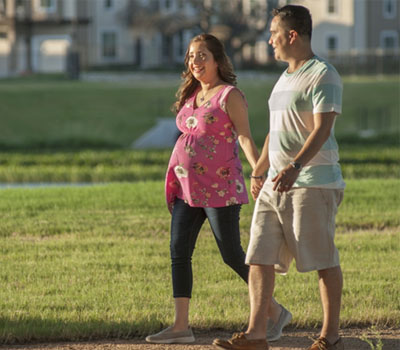 Pregnant woman and man holding hands