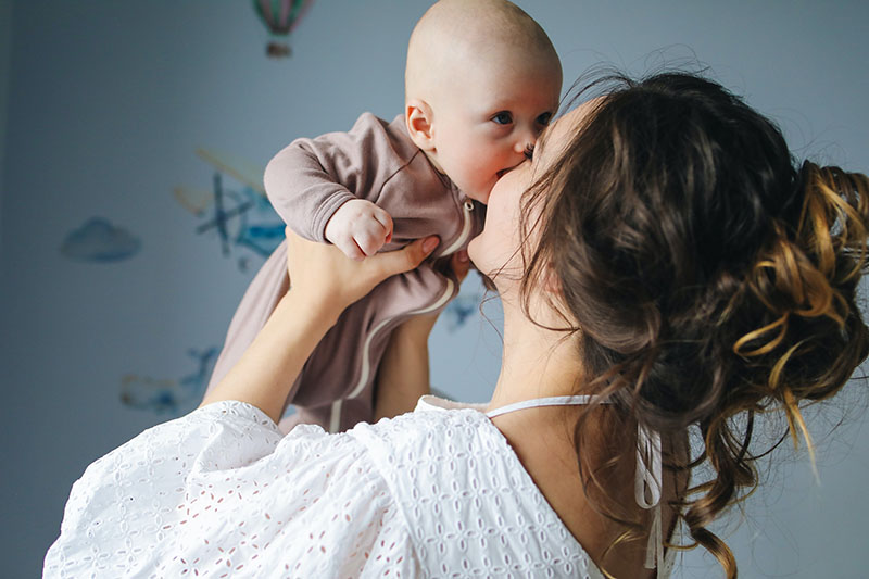 Mother kissing baby